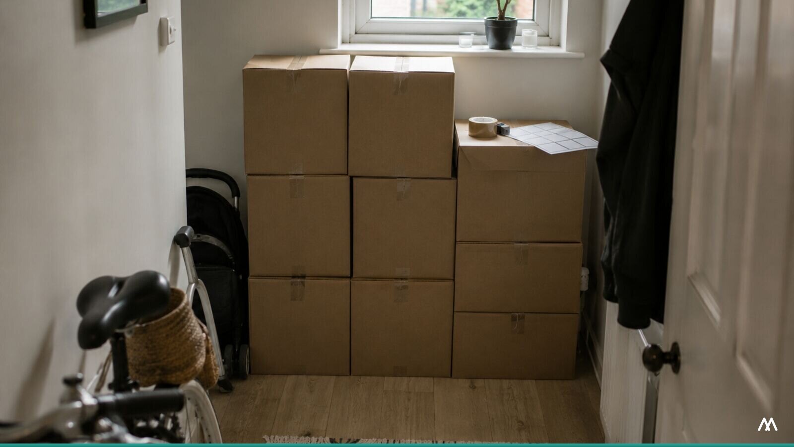 Cardboard boxes stacked in the hallway of a small home business.