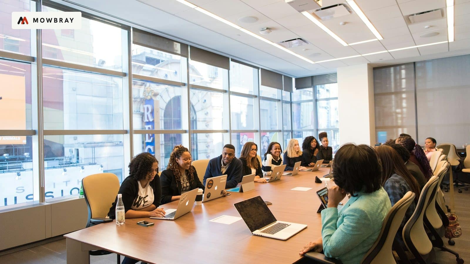 A team meeting around a long table in a bright office